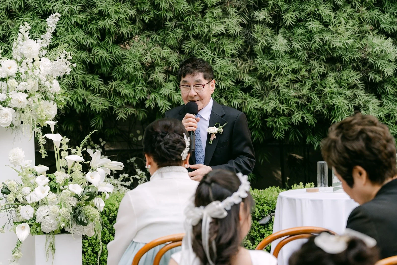 A guest at the microphone during the ceremony at Franciscan Gardens