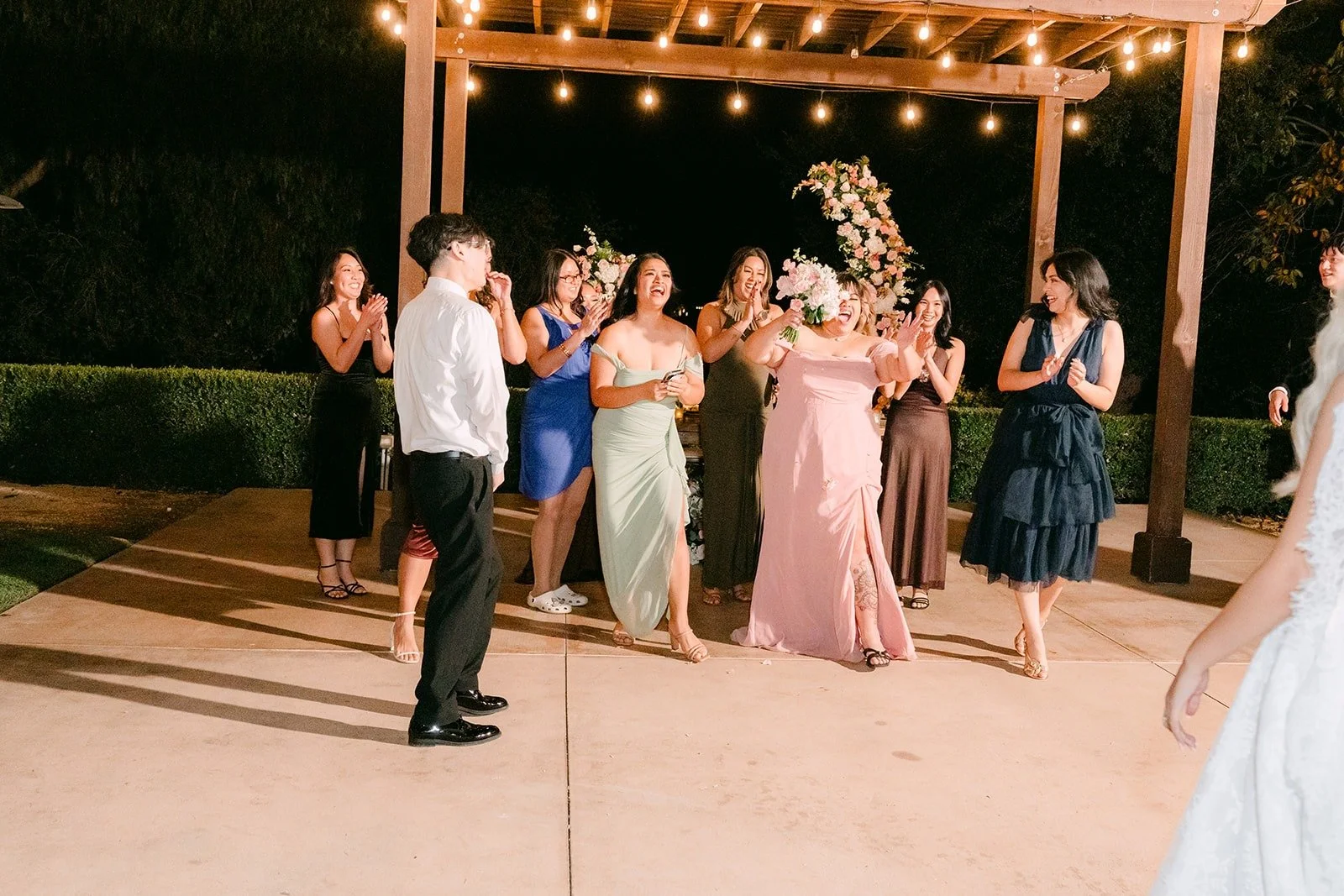 Guests waiting on the dance floor for the bouquet toss