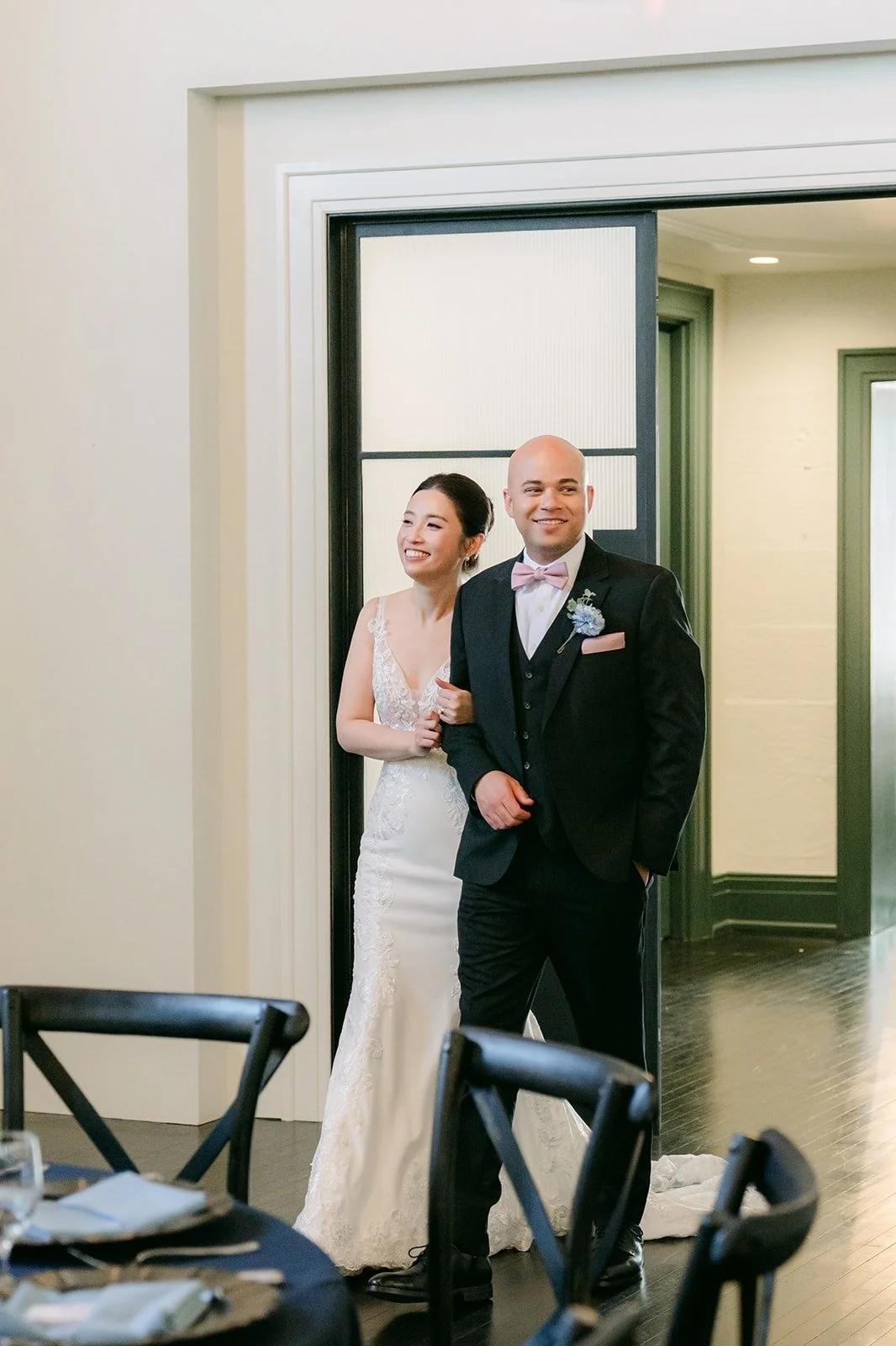 Elisa and Brandon step through the doors to see their reception room for the first time