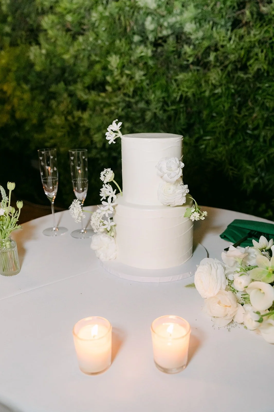 The cake table lit by candles as evening falls