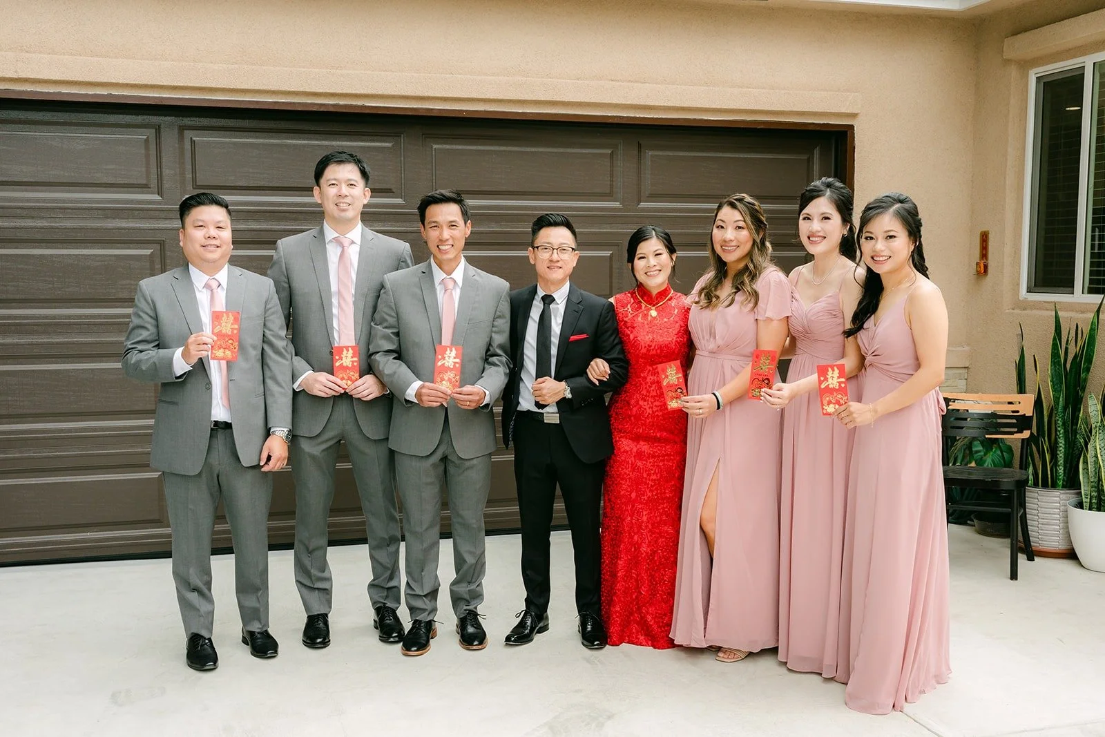 Xuemin, Alex and the wedding party lined up in front of the garage