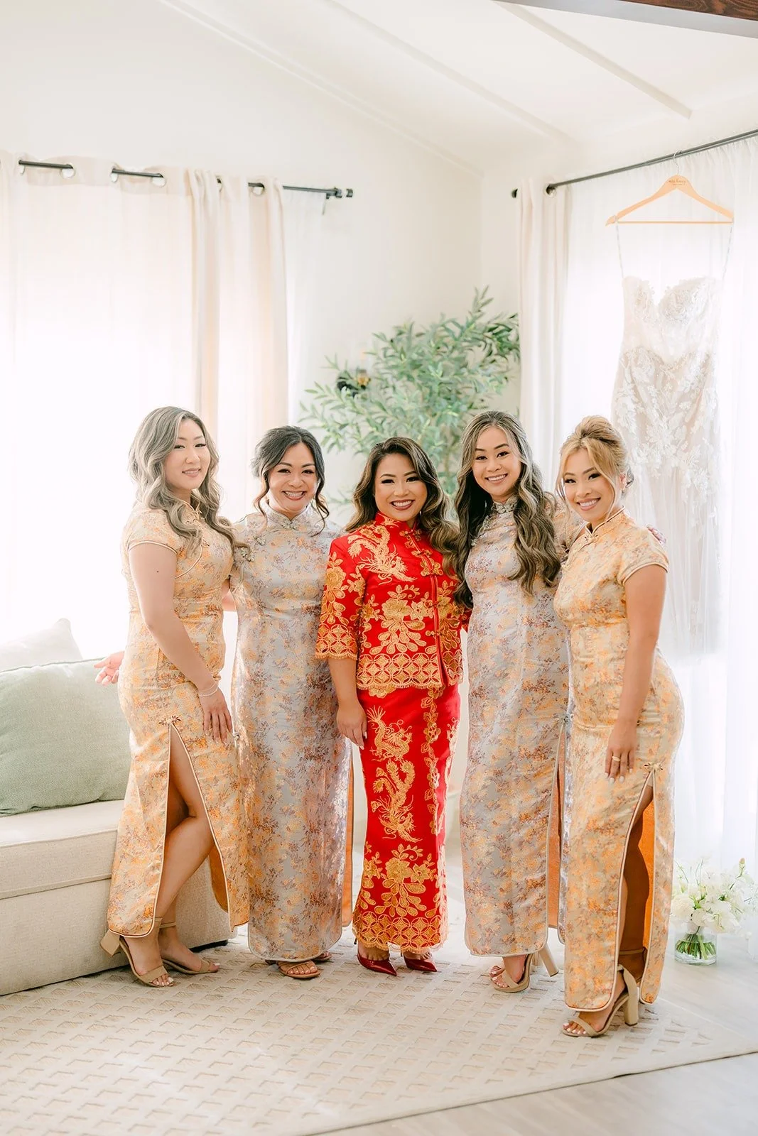 Candice in red with her bridesmaids in gold
