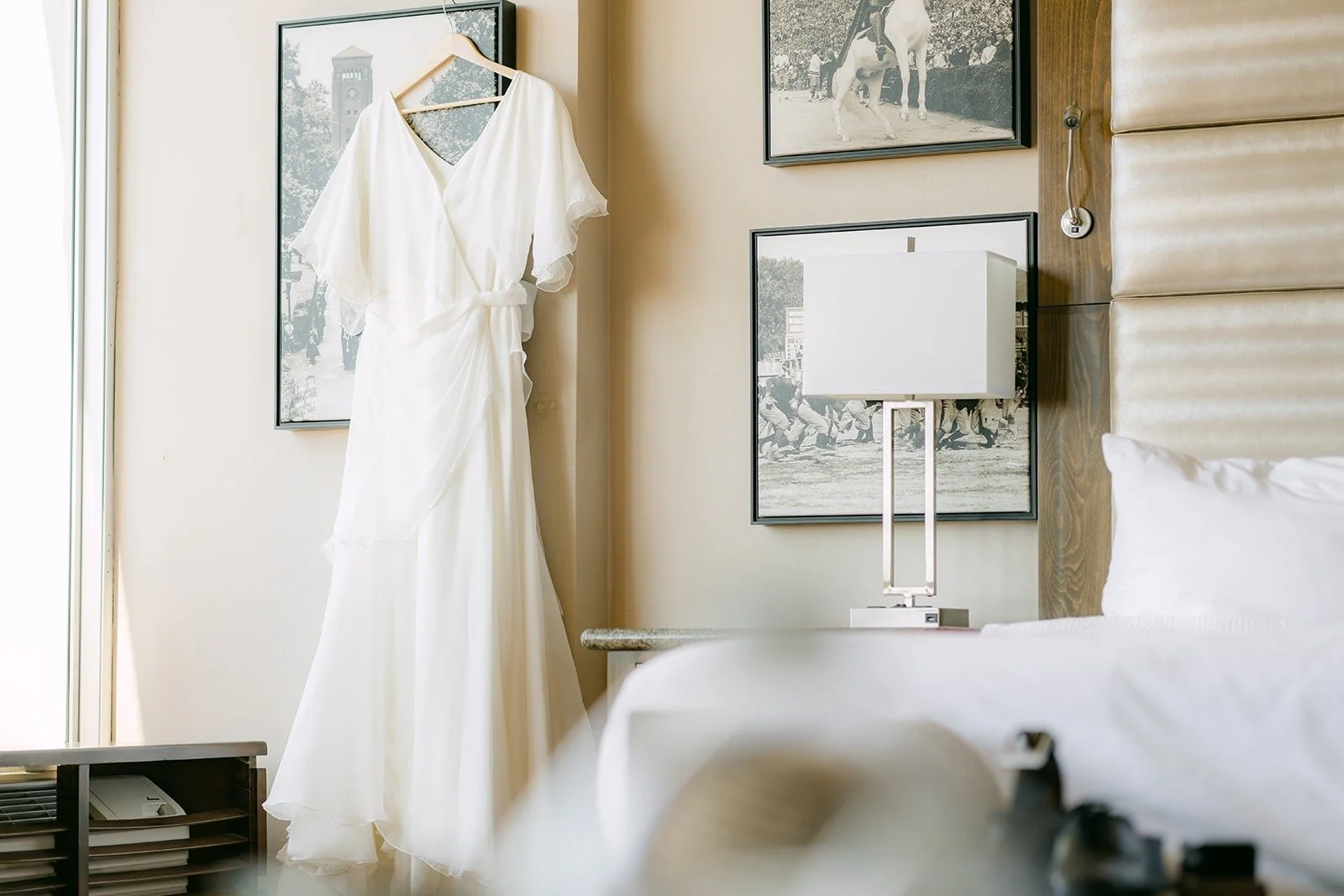 Jessie's wedding dress hanging in the hotel room