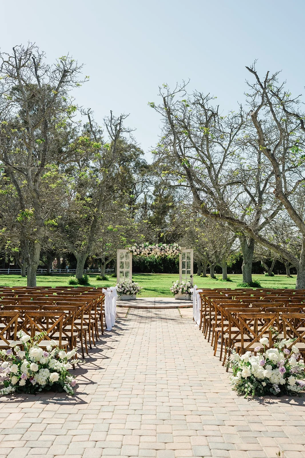 Empty ceremony aisle looking toward the floral arch