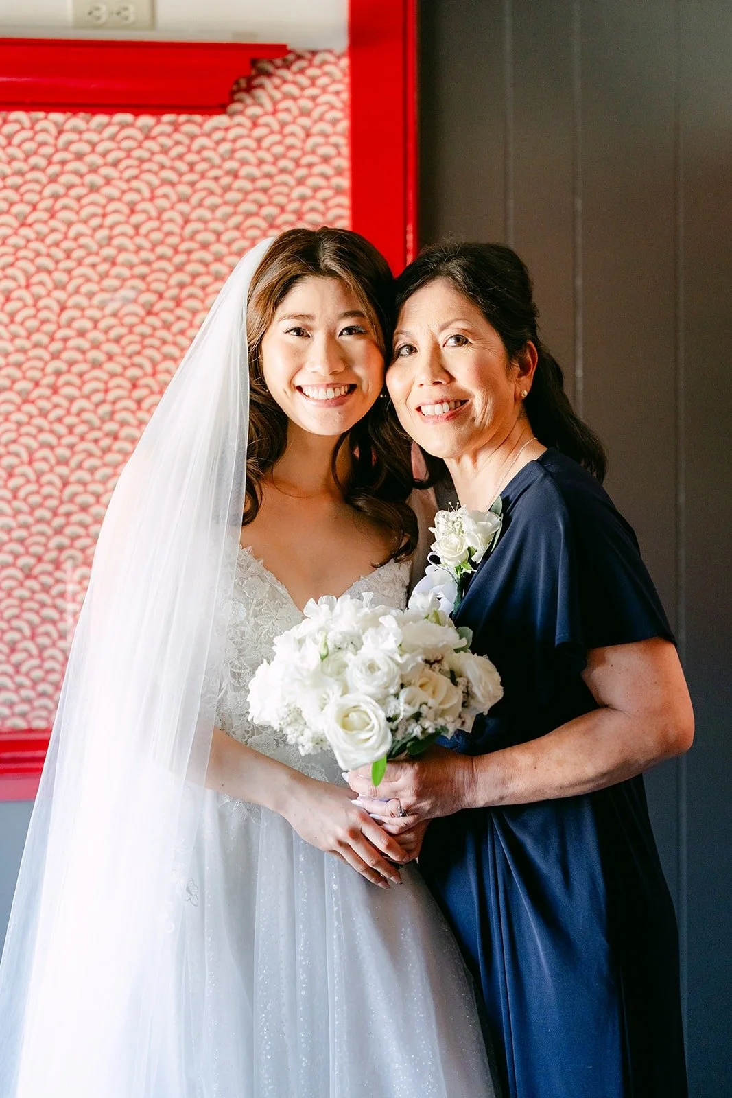 Valerie smiling beside a family member in a navy dress