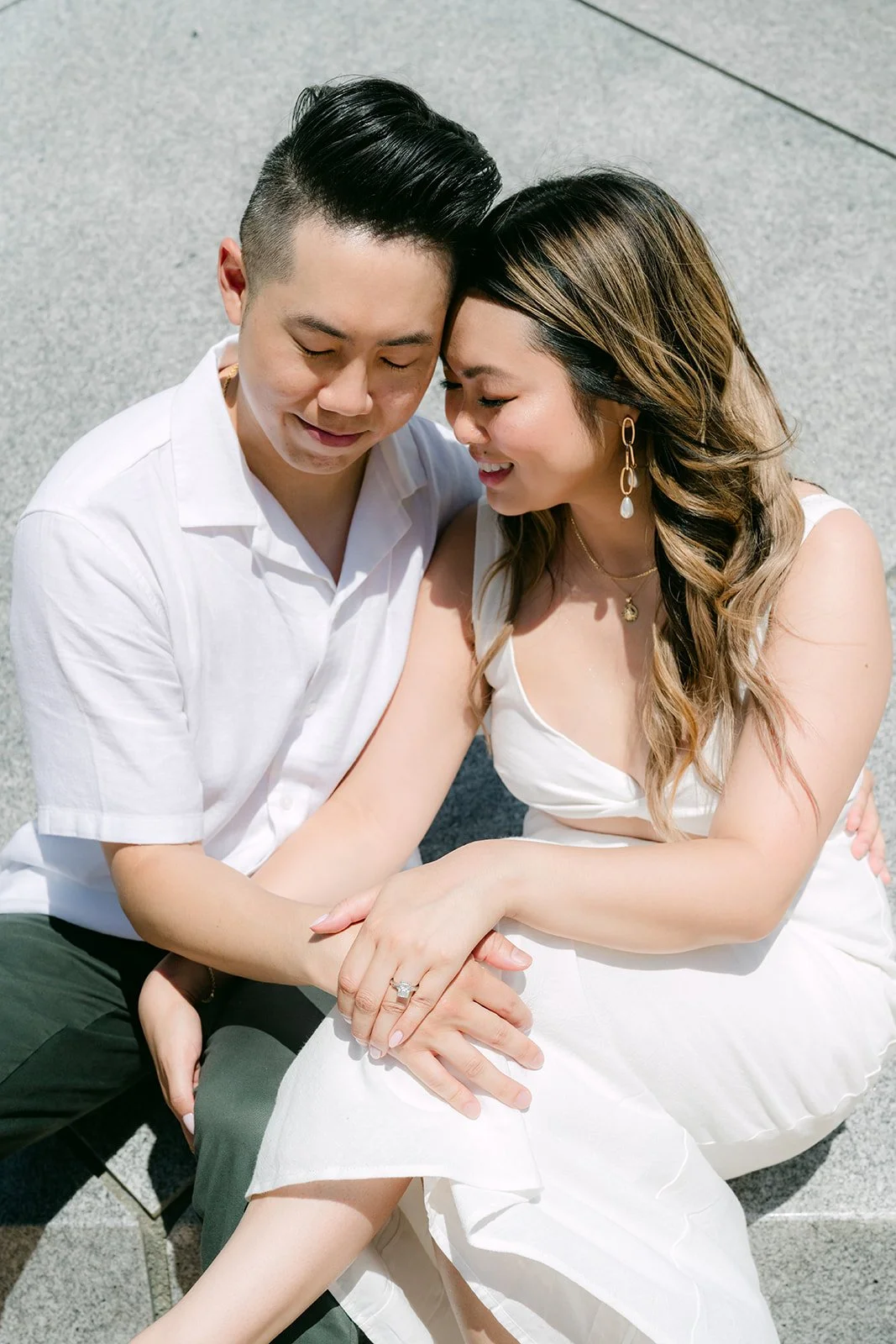 Stephanie and Alan cuddle at the base of the pyramid, photographed by One and Only Production.