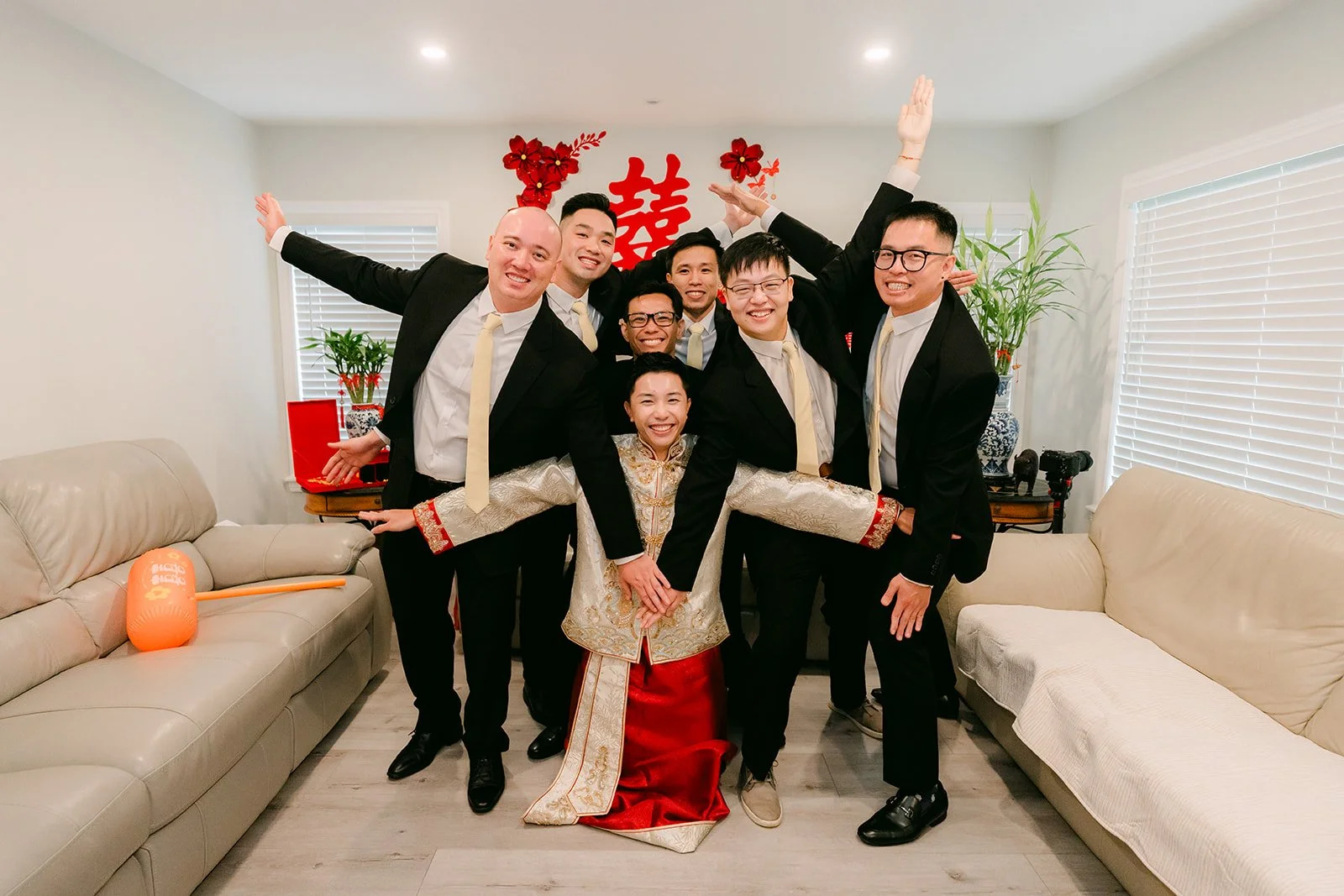 The groom and his groomsmen celebrating with the bride after getting through the door game.