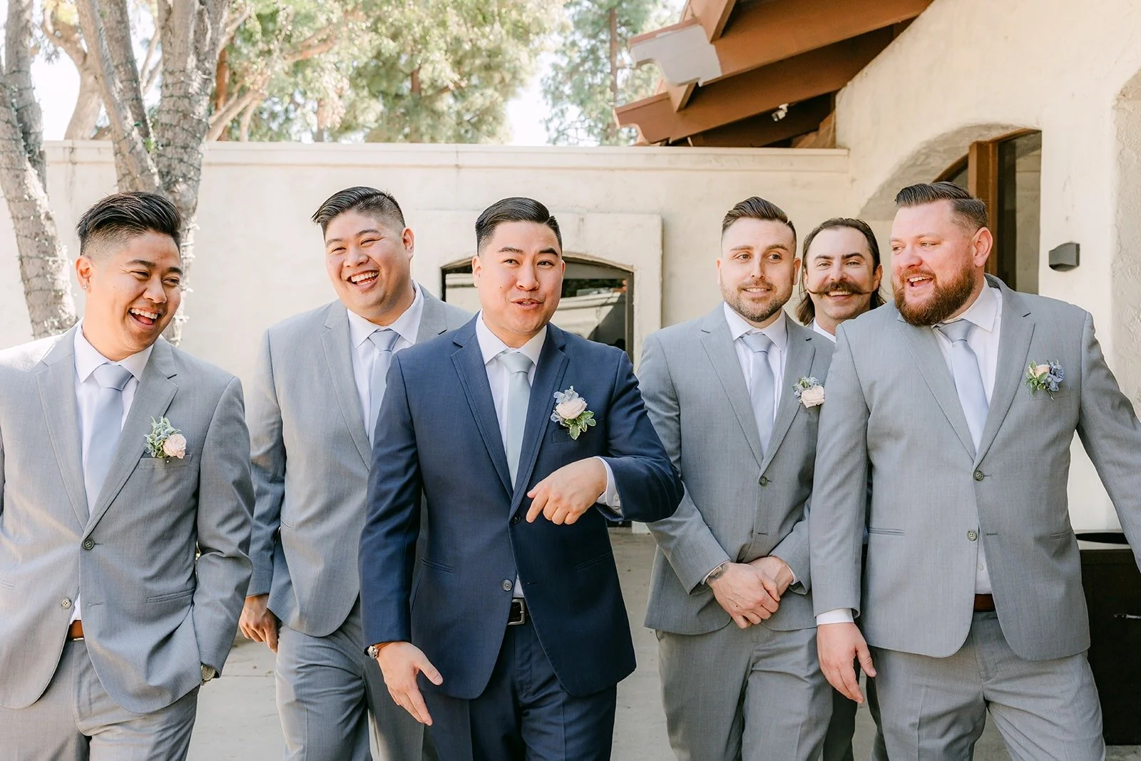 Jordan and the groomsmen laughing together