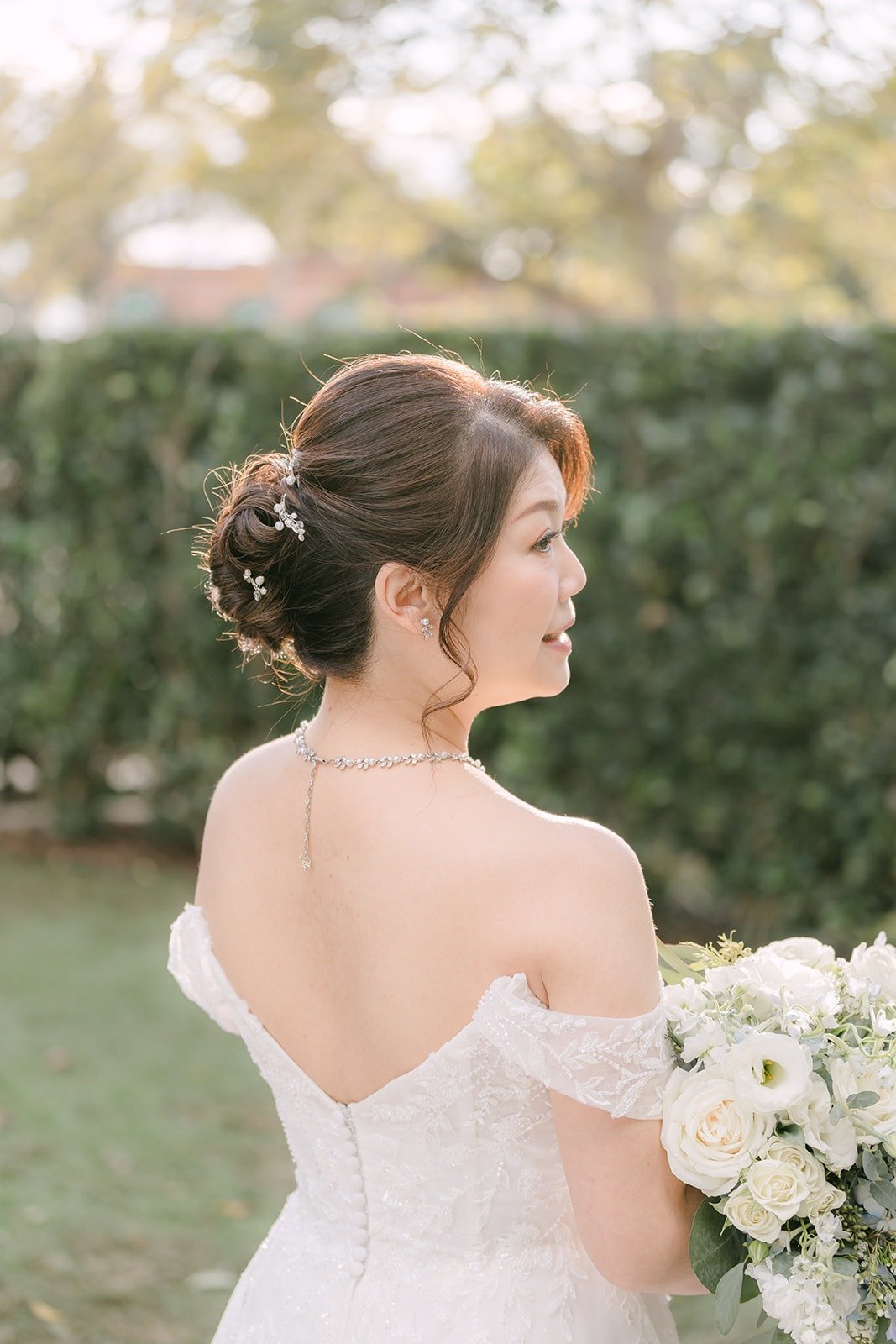 Sochi looks over her shoulder in her off the shoulder gown