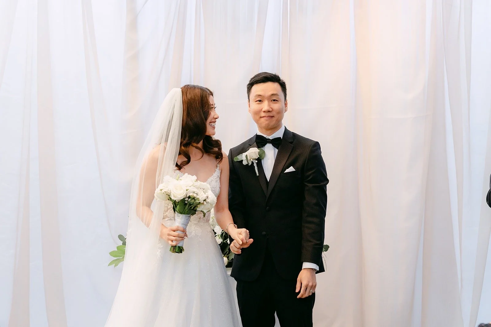 Valerie and Jason facing their guests as newlyweds