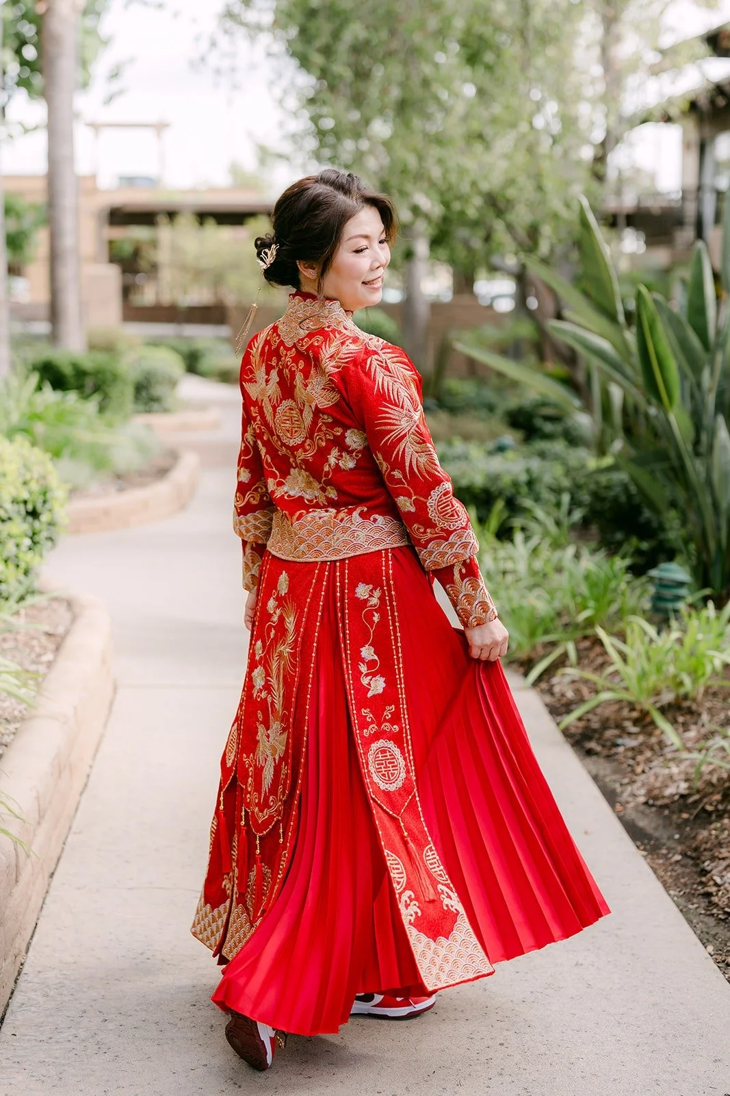 Sochi turns on the garden path in her red embroidered dress