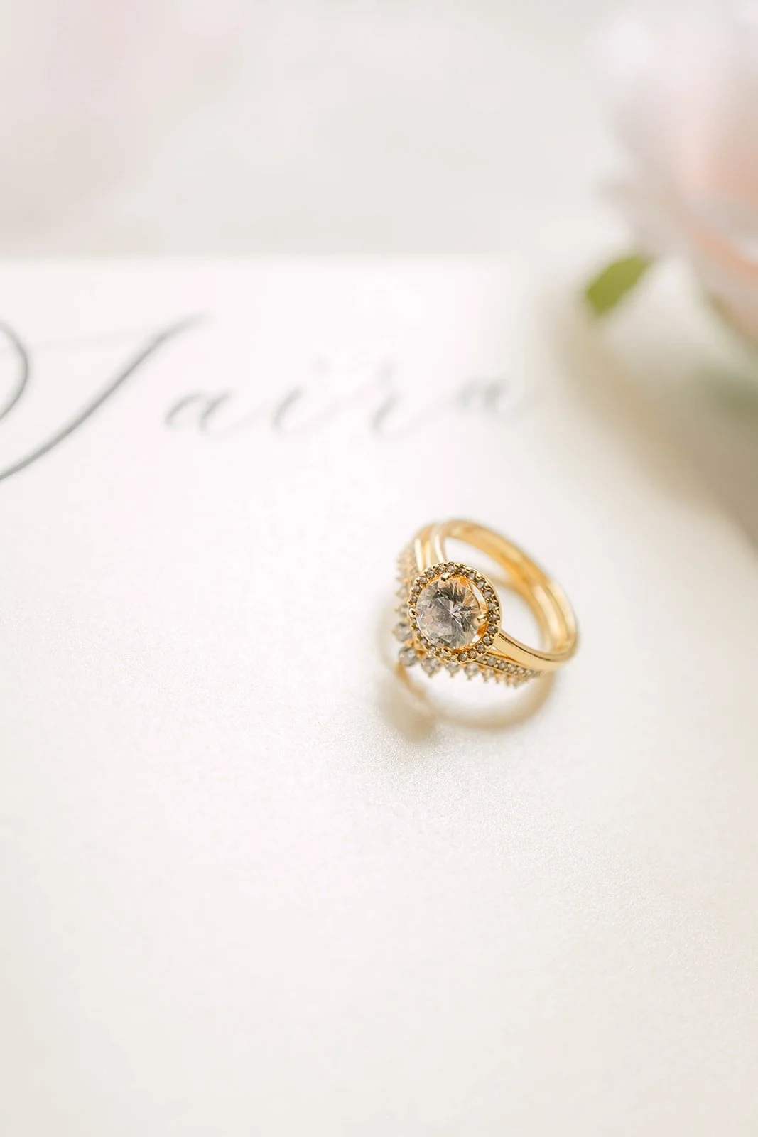 Saira's engagement ring resting on a card lettered with her name