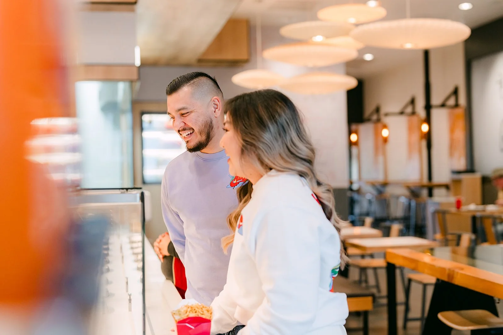 Linh and Ankush laughing together at the Panda Express counter.
