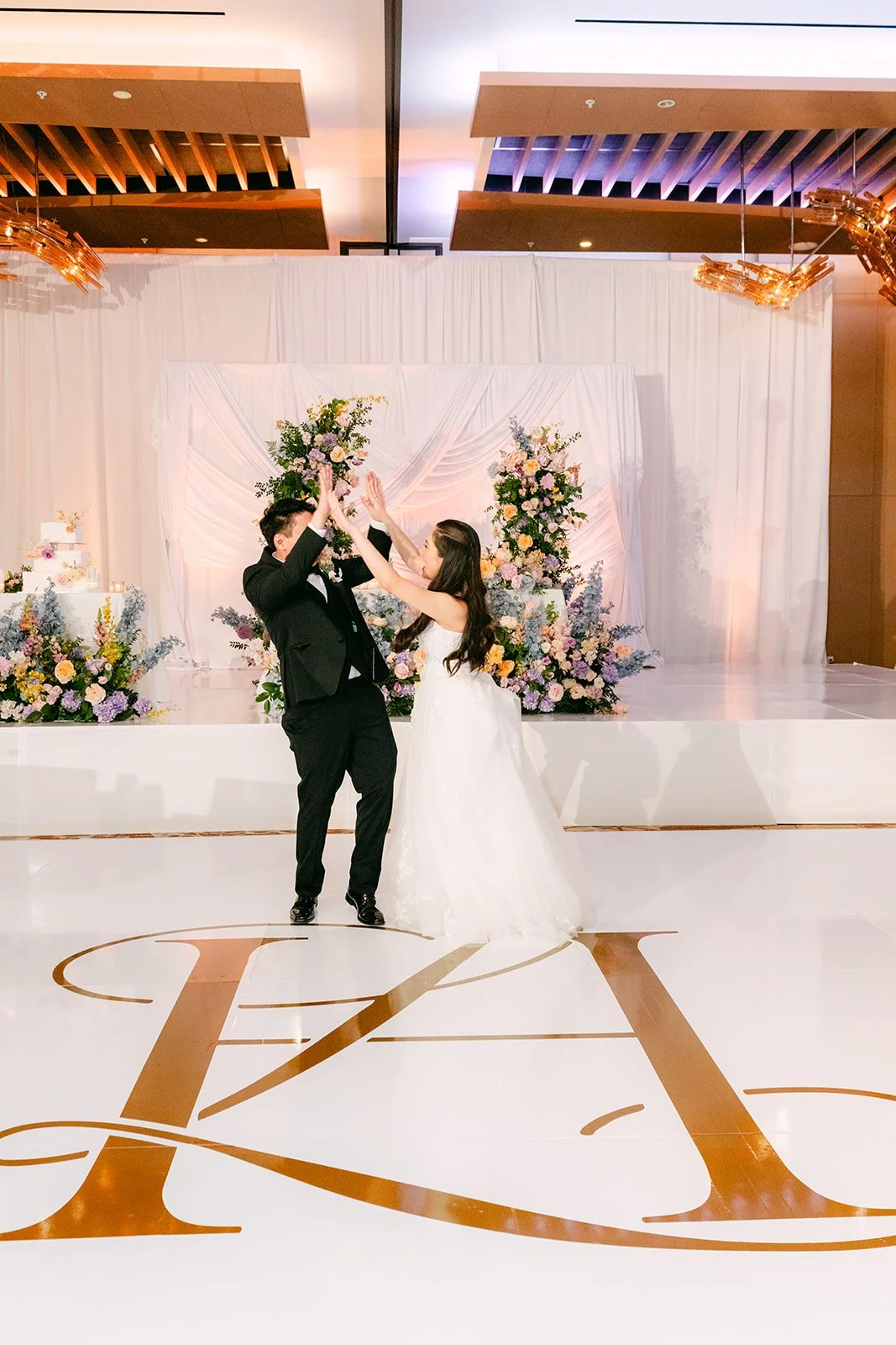 Linh and Hoan's first dance on their monogrammed dance floor
