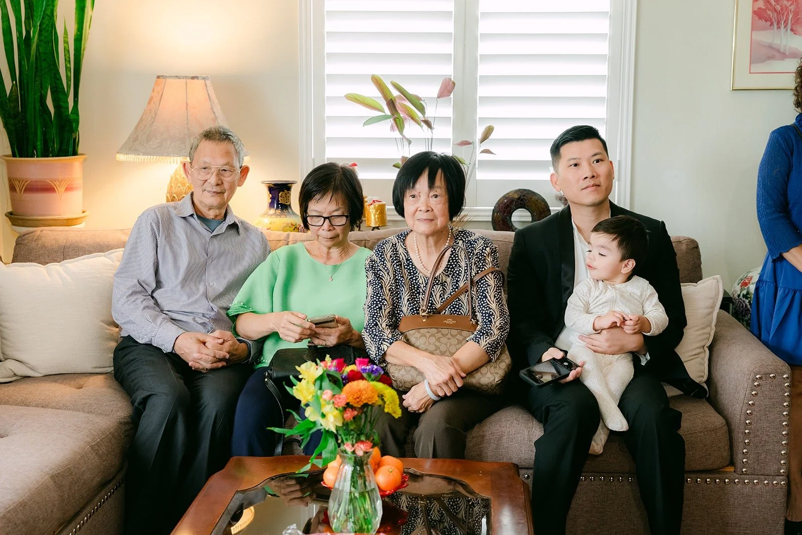 Family gathered on the sofa for the tea ceremony