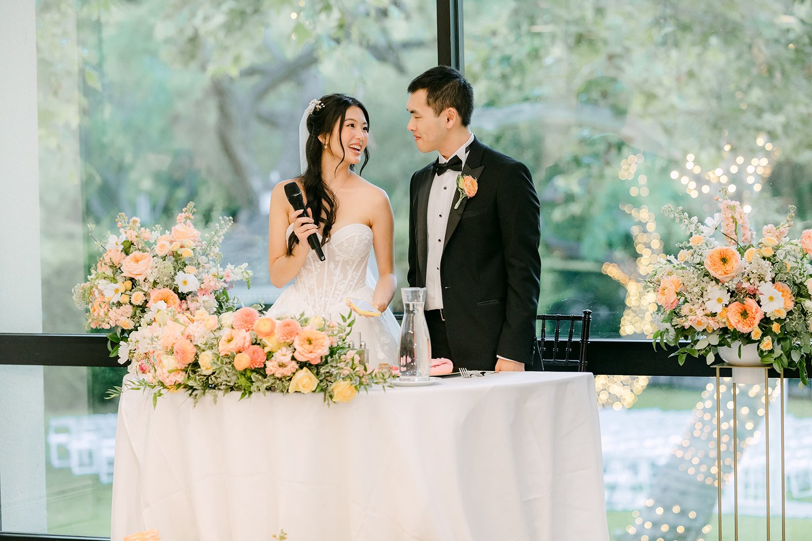 Clarissa and Austin listening at the sweetheart table