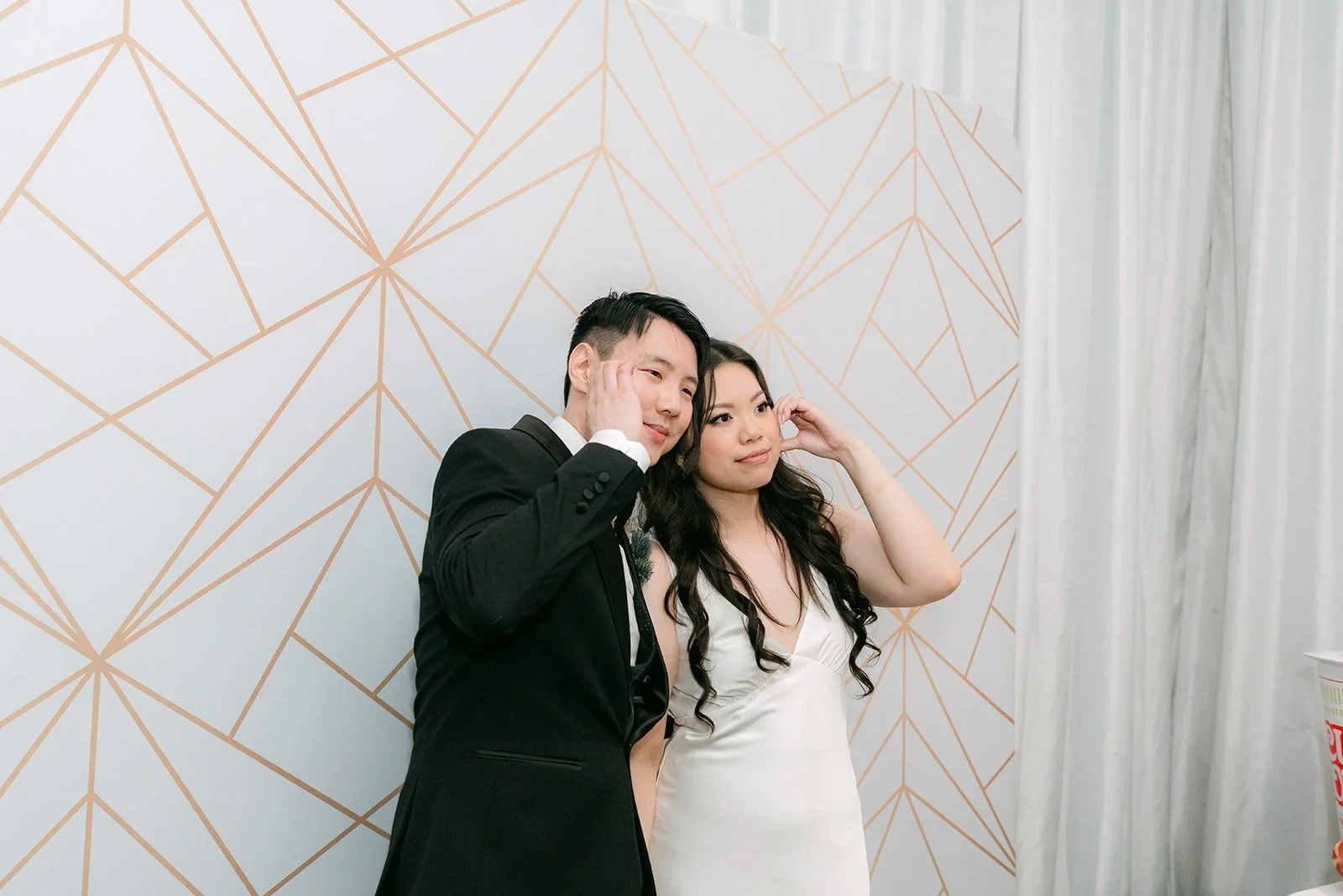 Emily and James posing in the photobooth