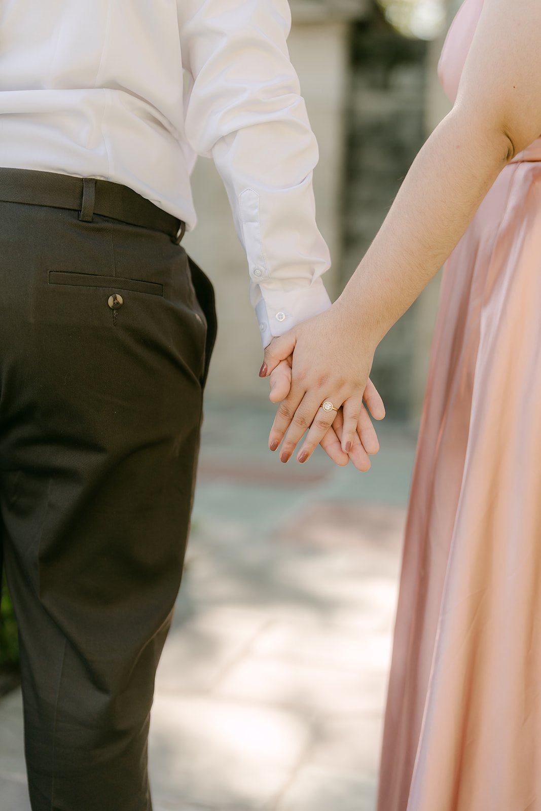Close-up of Saira and Matthew holding hands.