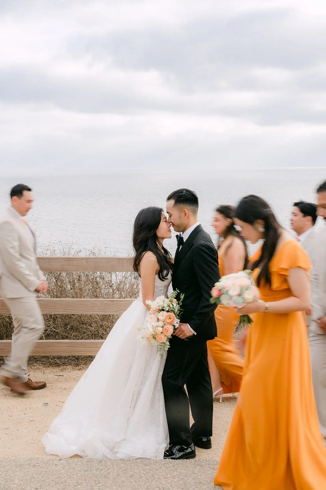 Wedding party cheering around Kim and Vincent on the bluff