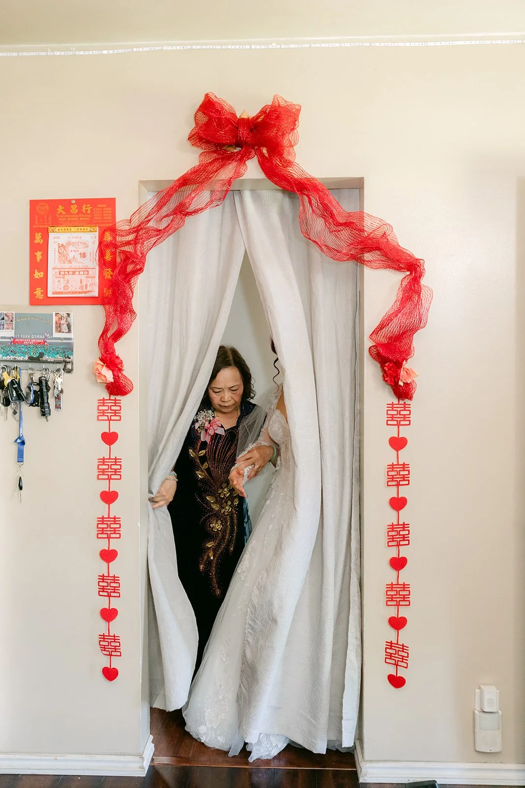 Curtained doorway tied with a red bow.