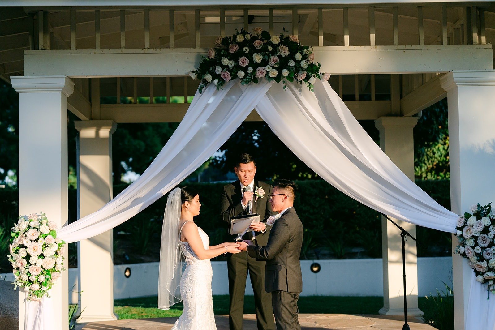 Xuemin and Alex under the gazebo with the officiant