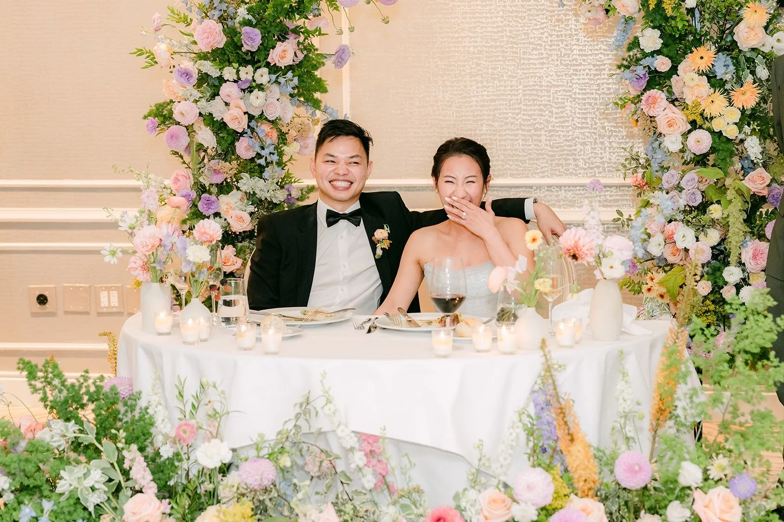 Kylie and Mario laughing during a toast