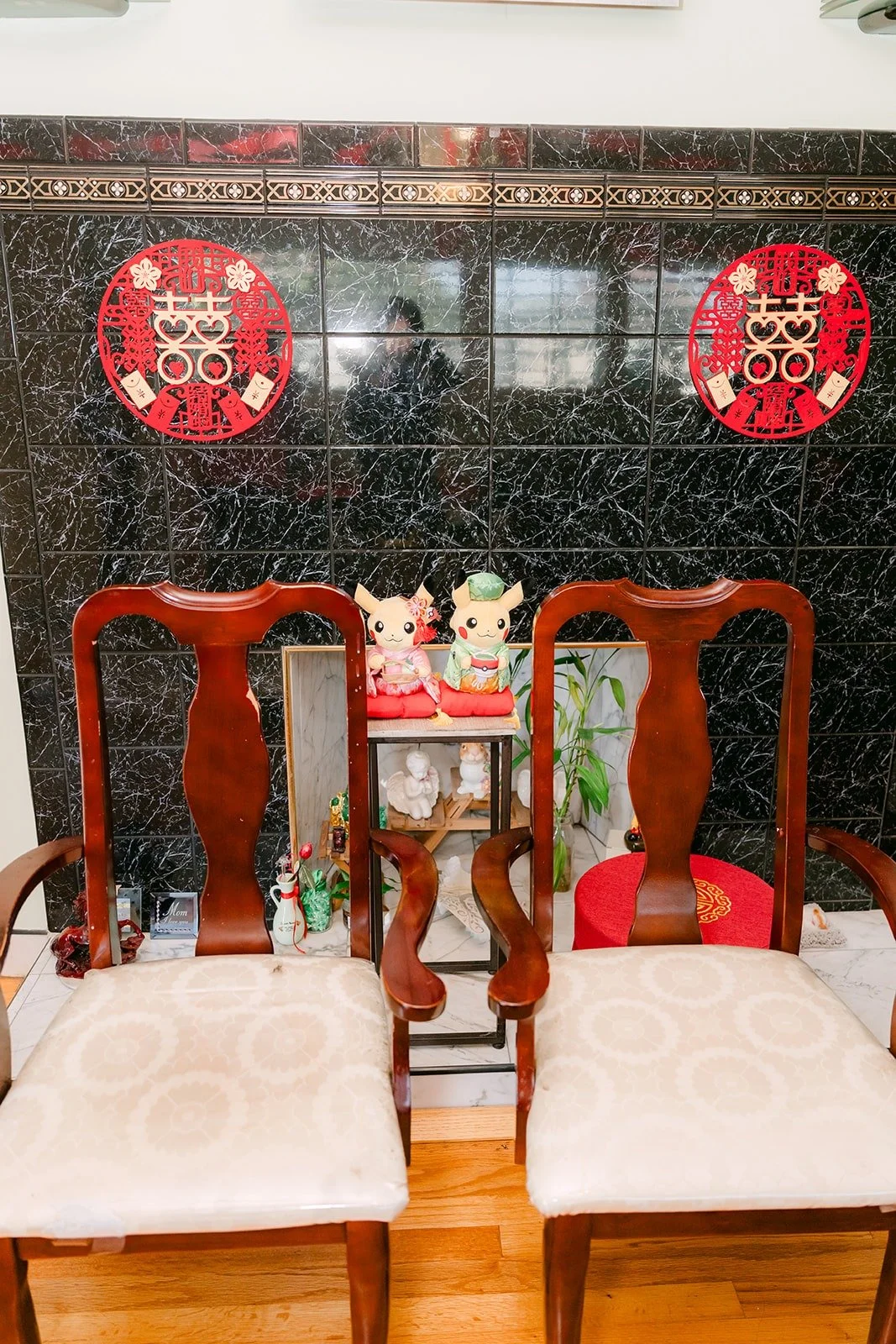 Two chairs set in front of red double happiness decorations for the tea ceremony