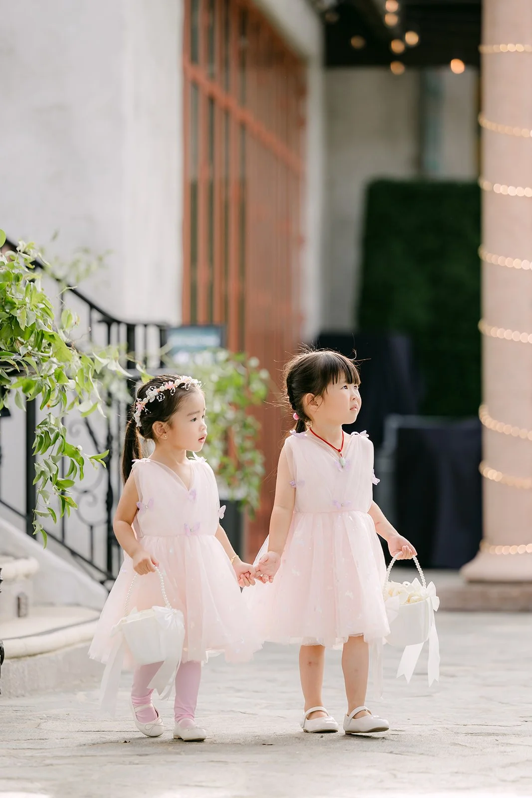 Flower girls holding hands before the processional