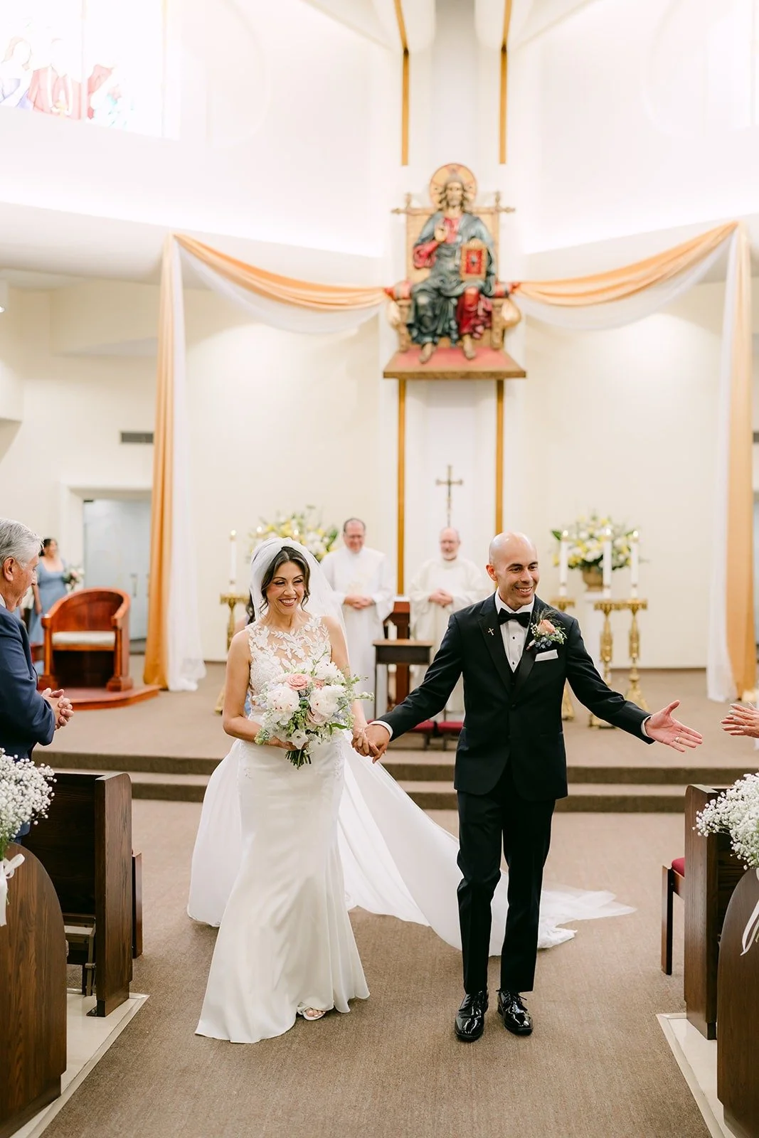 Francesca and Daniel cheer as they walk back down the aisle