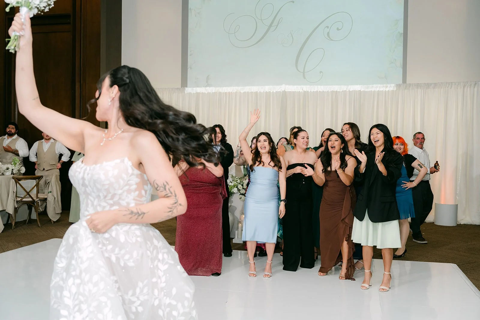 Fernanda tossing her bouquet.