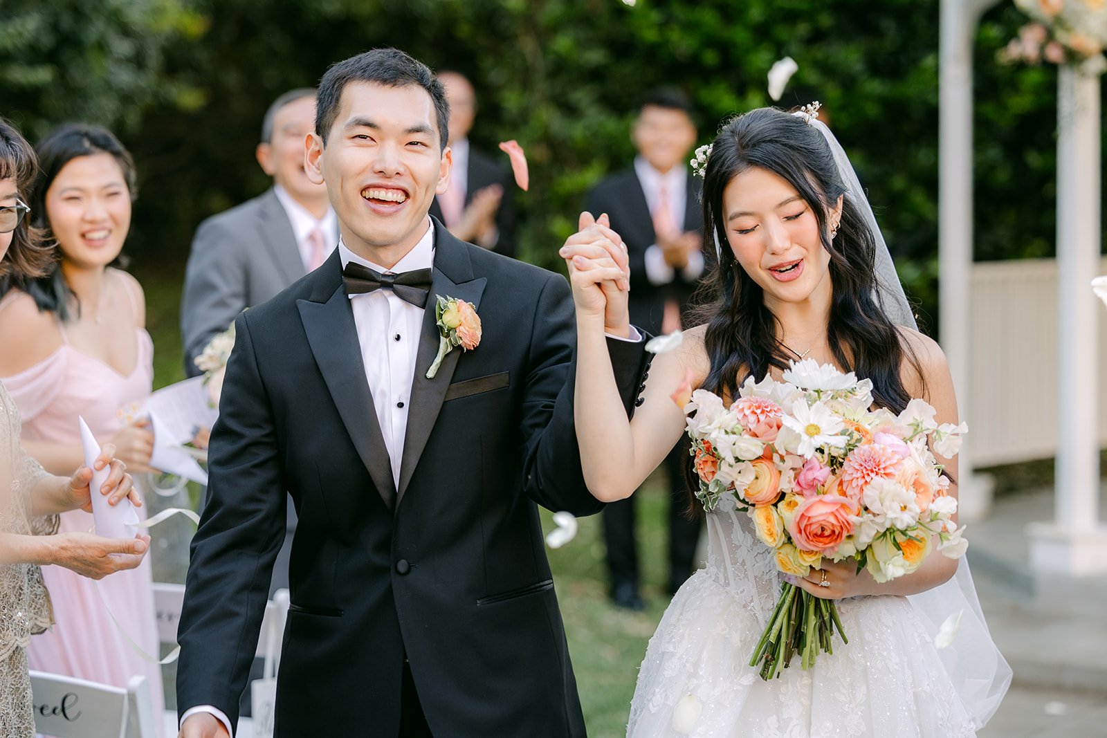 Clarissa and Austin cheering up the aisle as newlyweds