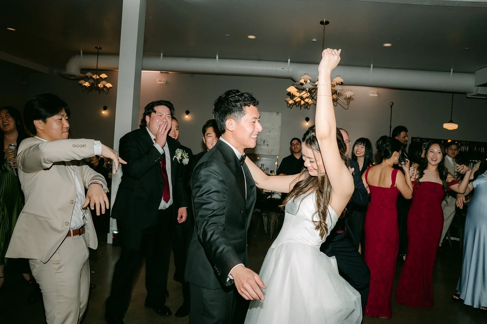 Jadee and friends dancing with their arms up