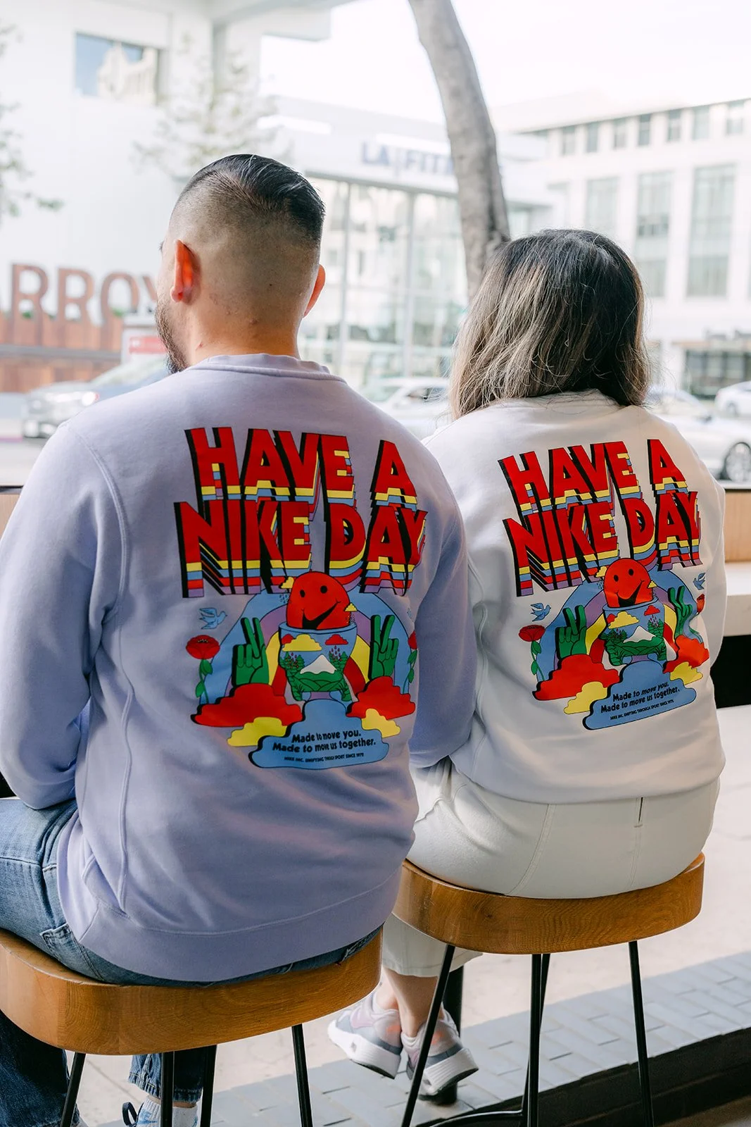 Linh and Ankush seen from behind in matching sweatshirts at the window counter.