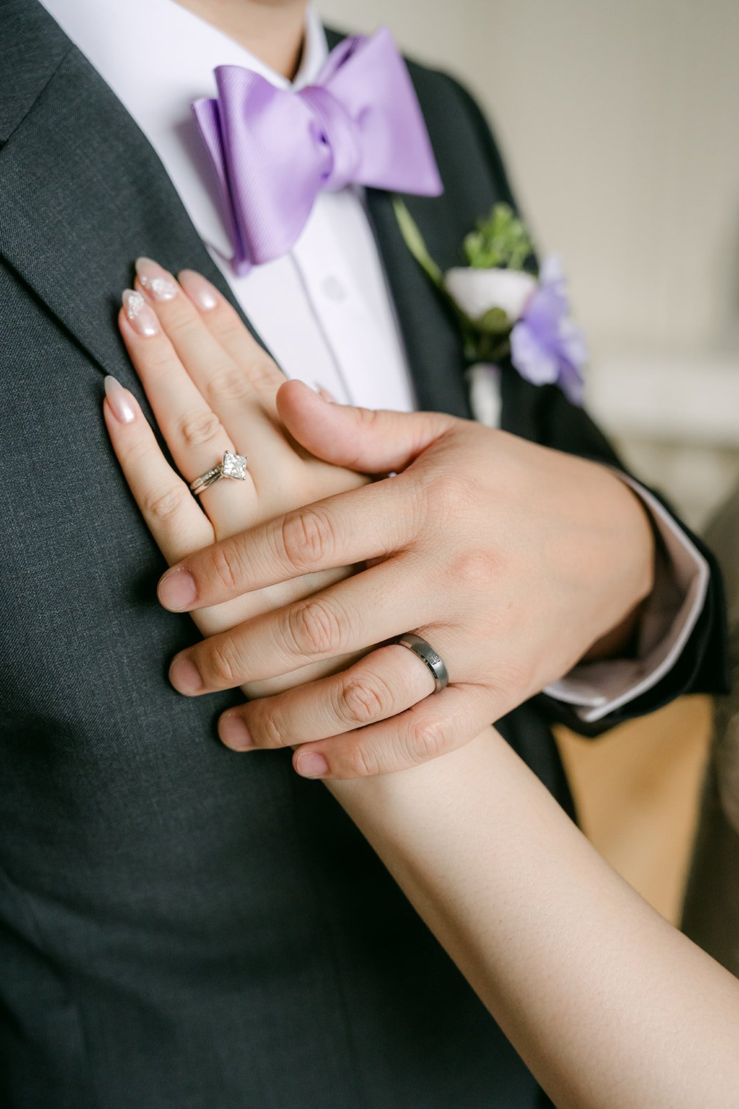 Mary's hand on Patrick's lapel with her ring