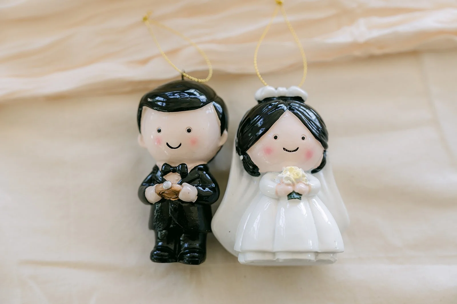 Bride and groom figurines on the cake, photographed by One and Only Production