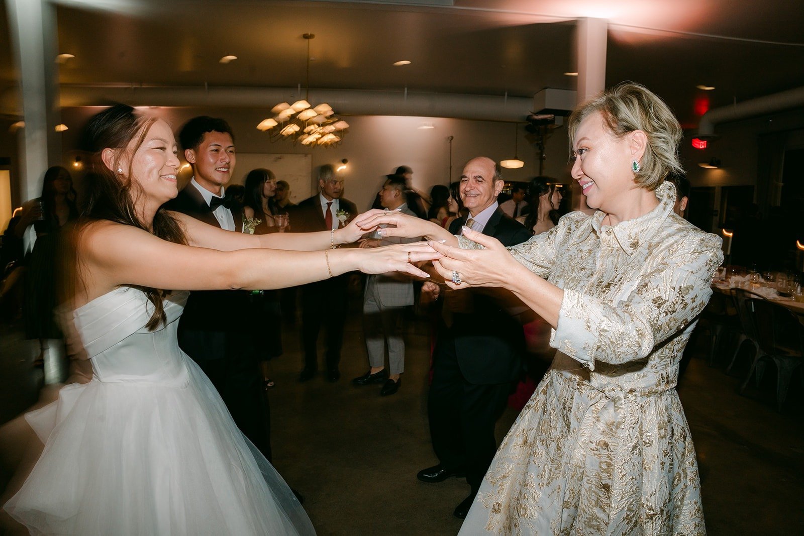 Jadee dancing hand in hand with a guest