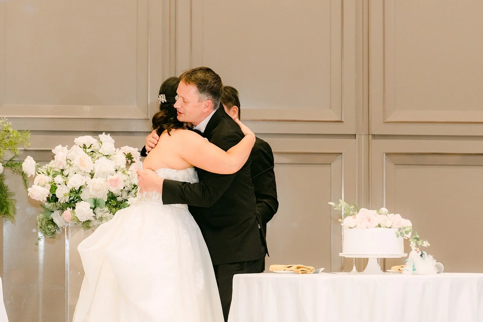 Stella hugging a speaker after his toast