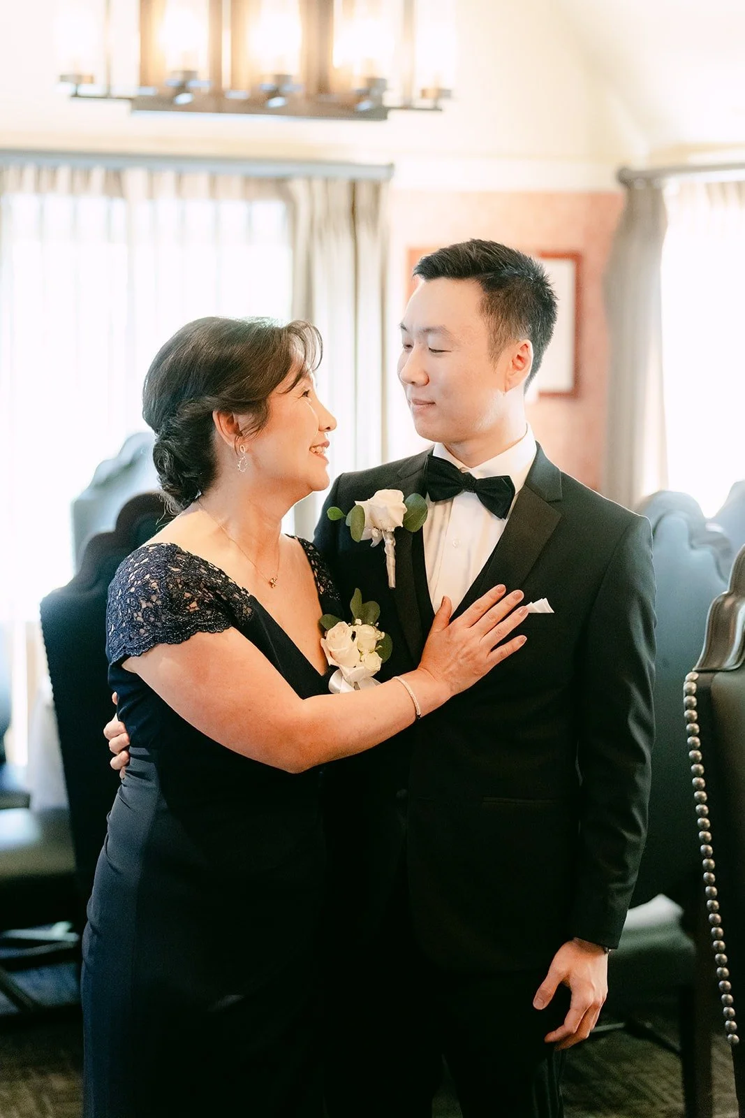 A family member fixing Jason's boutonniere