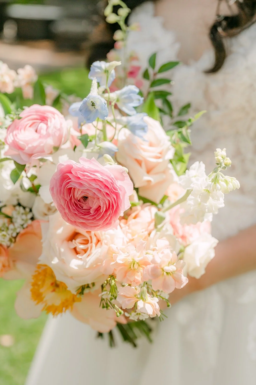 A close up of Natalie's pastel bouquet with pink peonies and peach roses