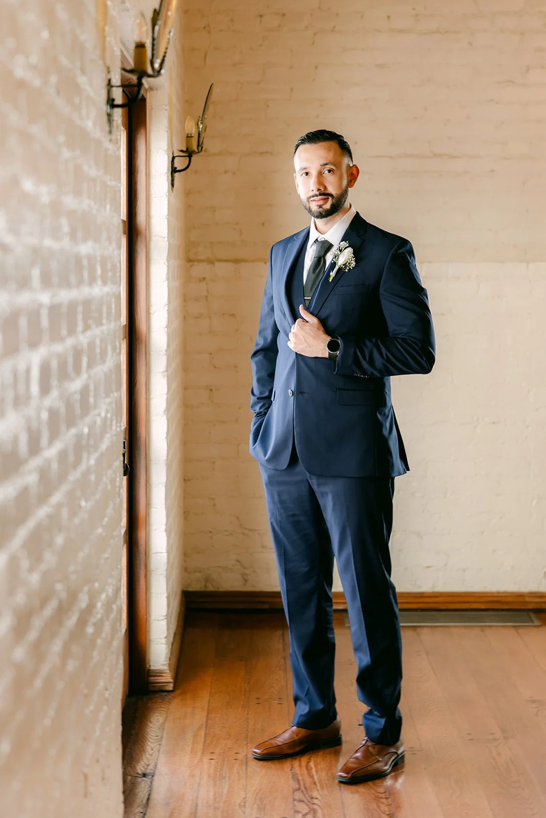 Danny standing by the window of the groom's room
