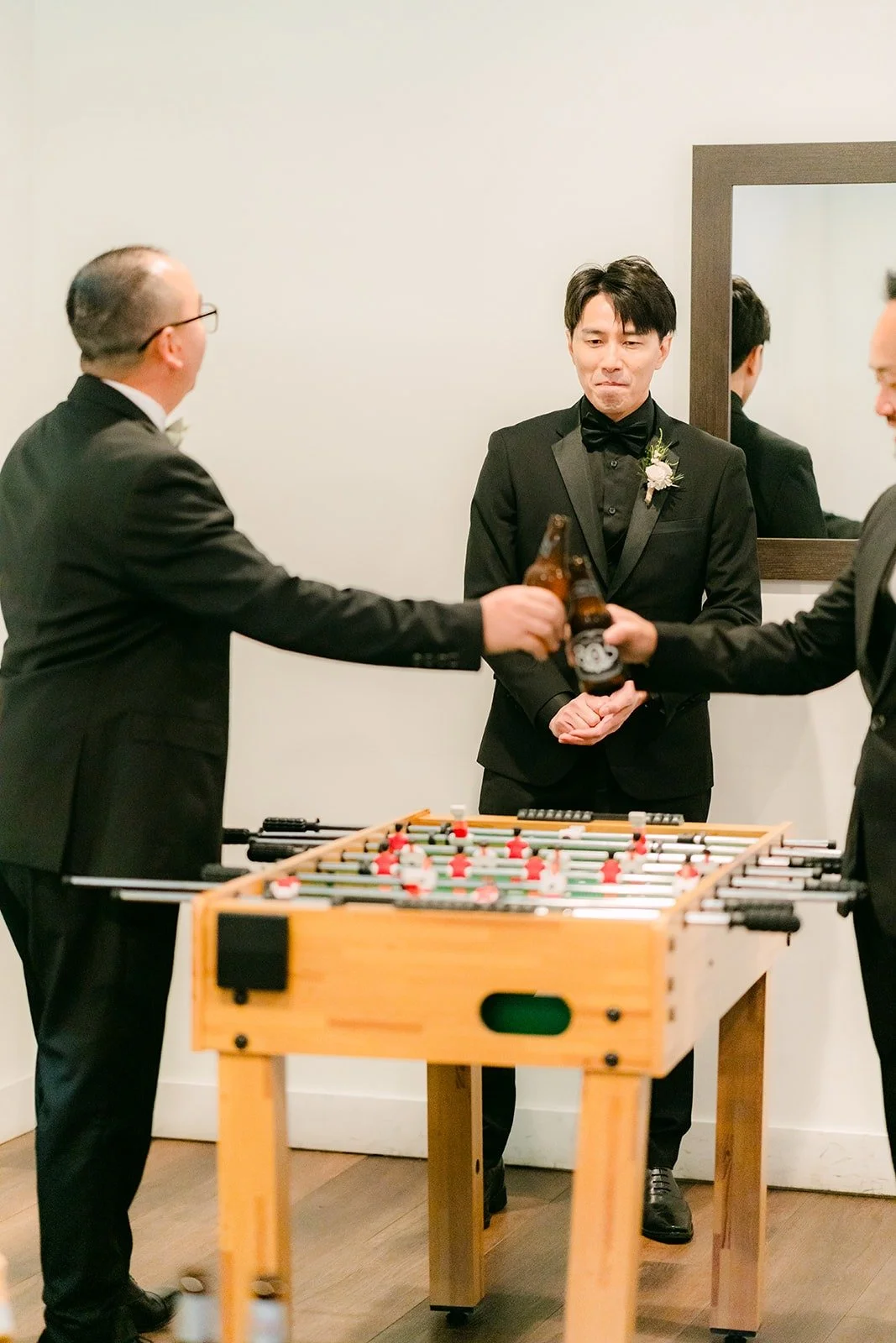 Fong and his groomsmen playing foosball in the groom's suite
