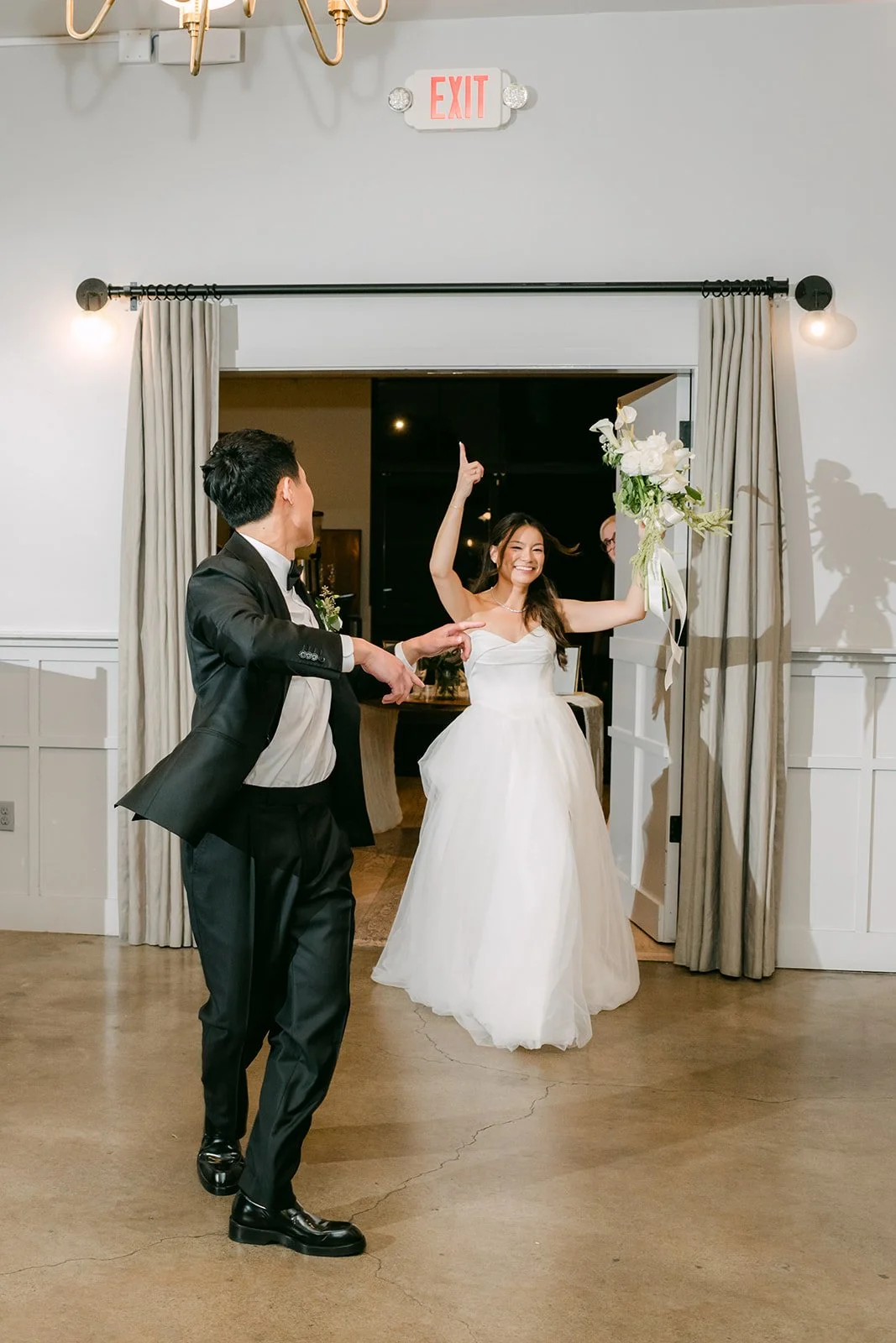 Wedding party pair entering through the doorway