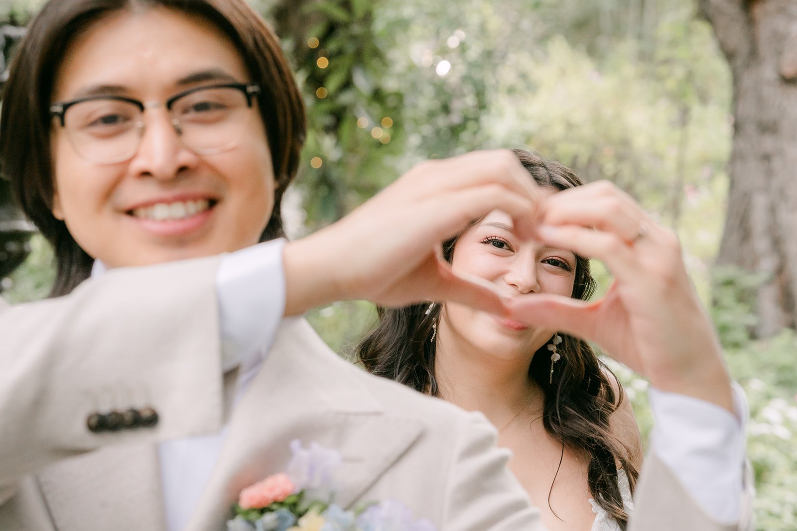 Kat and Mike making a heart with their hands