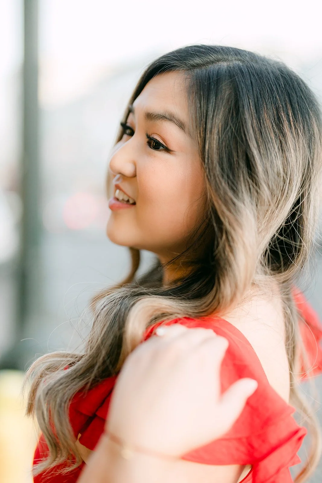 Close portrait of Linh looking away in golden light.