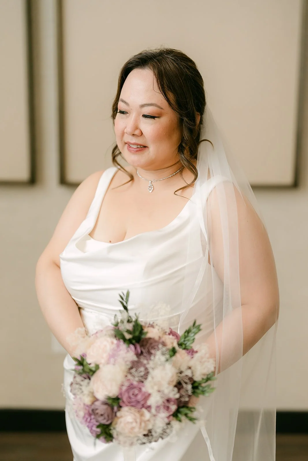 Mai smiling with her bouquet, photographed by One and Only Production.