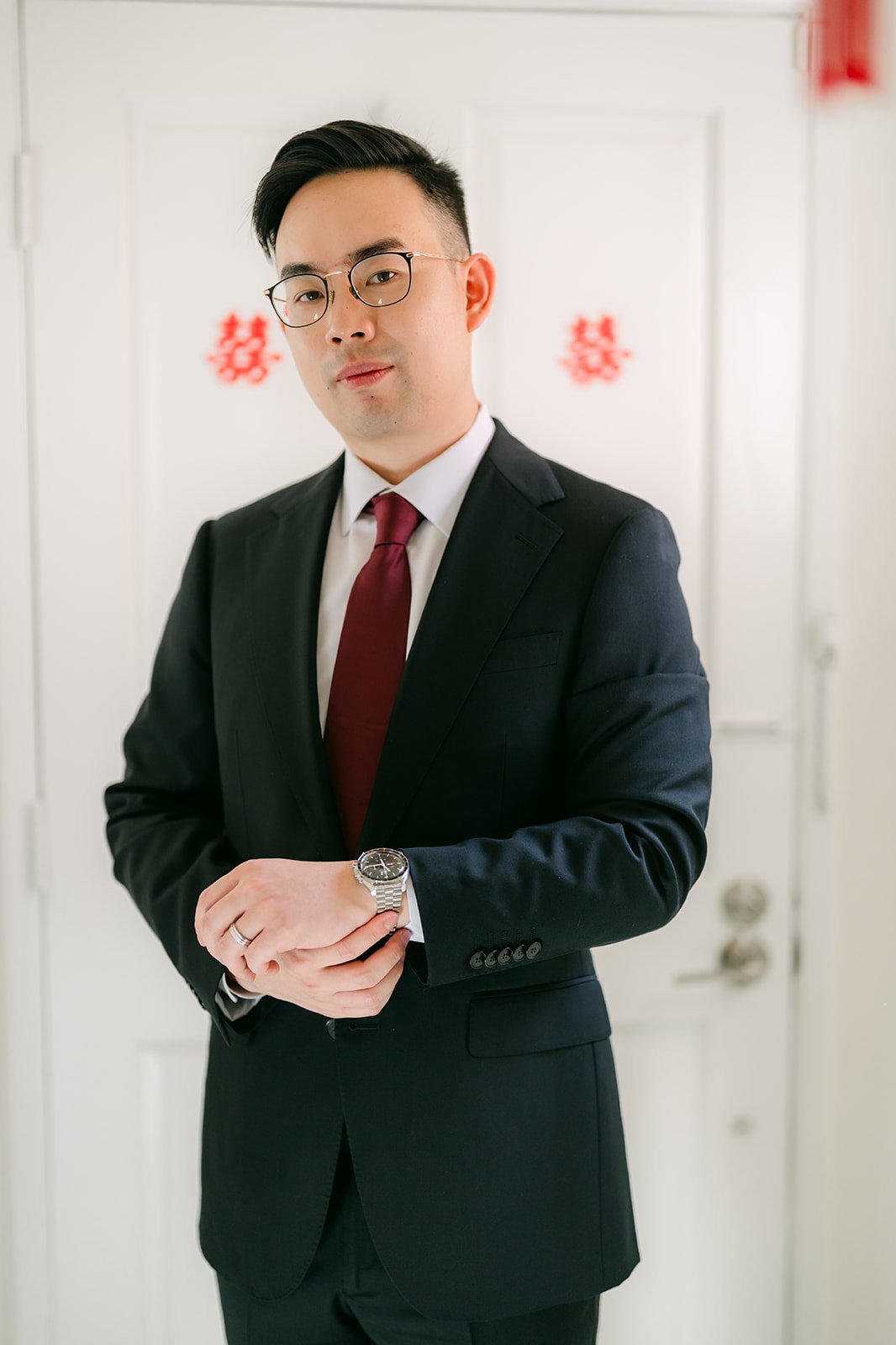 Ken in a dark suit and red tie.