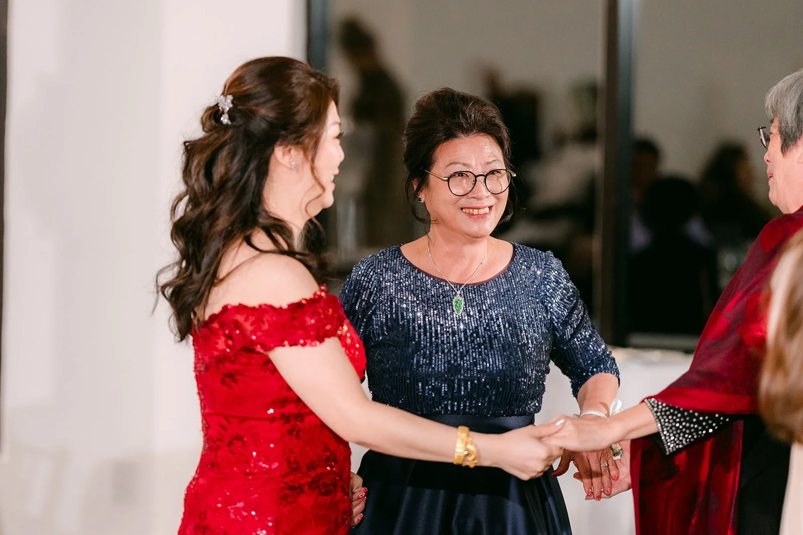Sochi dances with a family member in a blue sequin dress