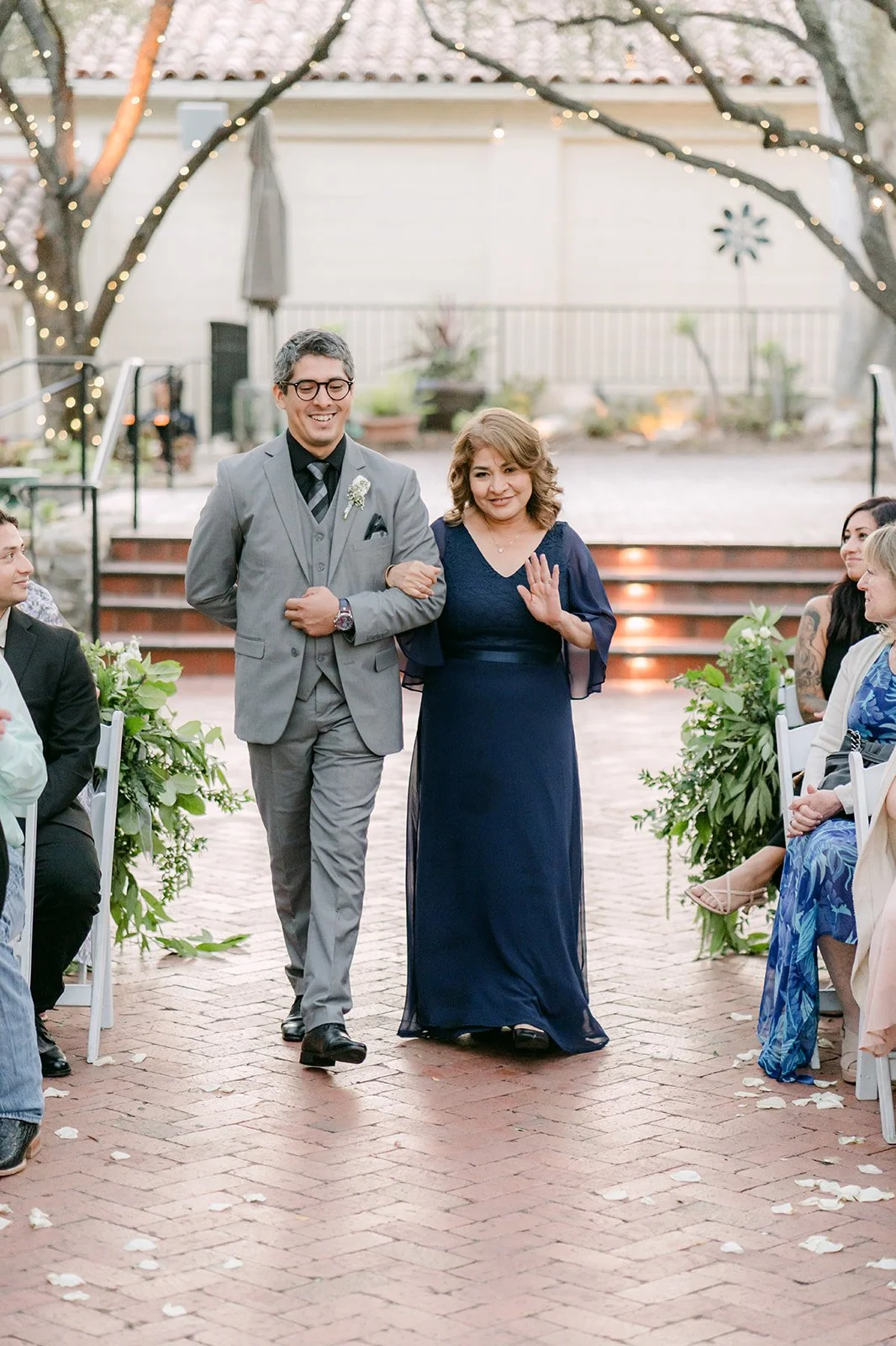 Mariana's mom walking down the aisle with her son