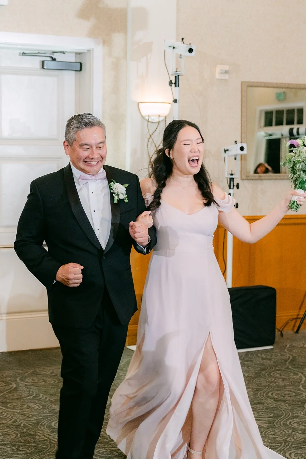 Members of the wedding party making their entrance into the ballroom