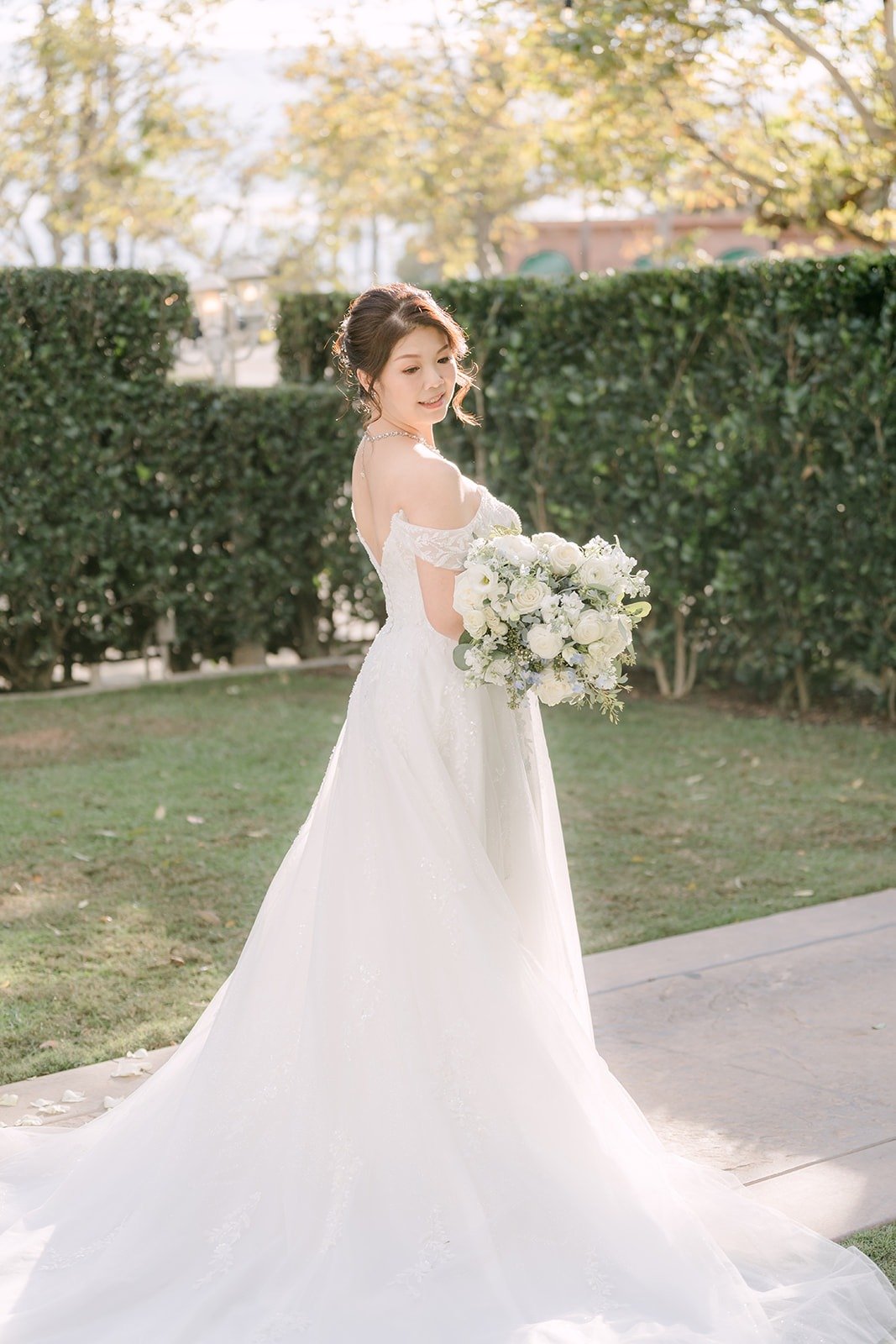 Sochi in her gown and long train on the lawn at Sierra La Verne